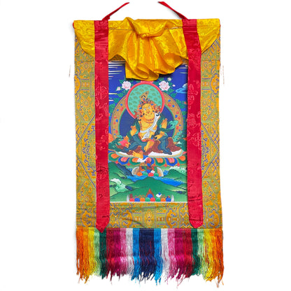 Rotolo thangka Dzambala giallo con broccato giallo oro, nastri di seta rossi e frange colorate, 44 x 79 cm
