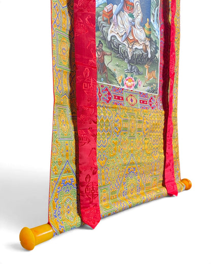 Milarepa thangka, bottom detail with rod with amber-coloured ends on yellow brocade
